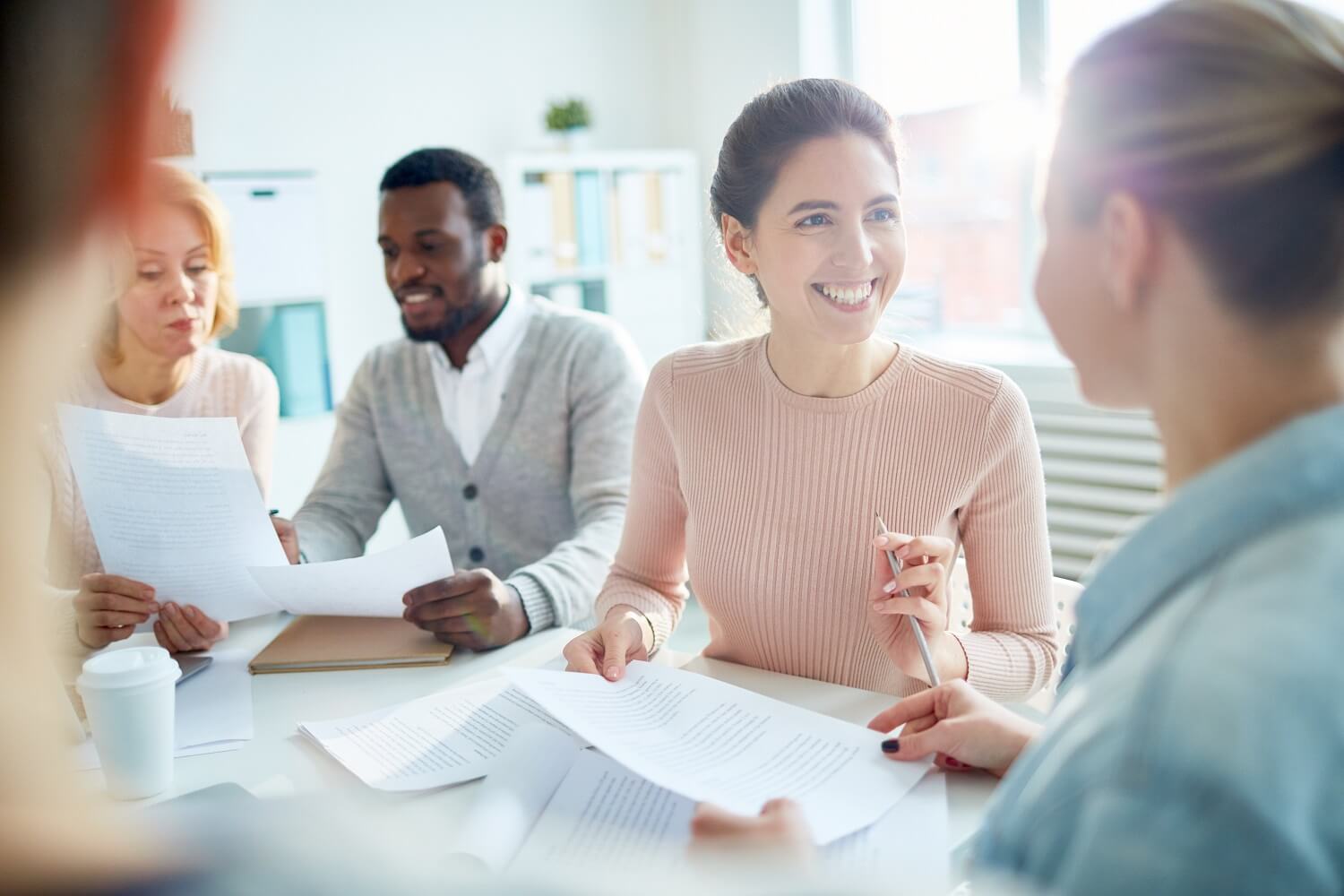 female accountant smiling at colleague during accounting firm meeting